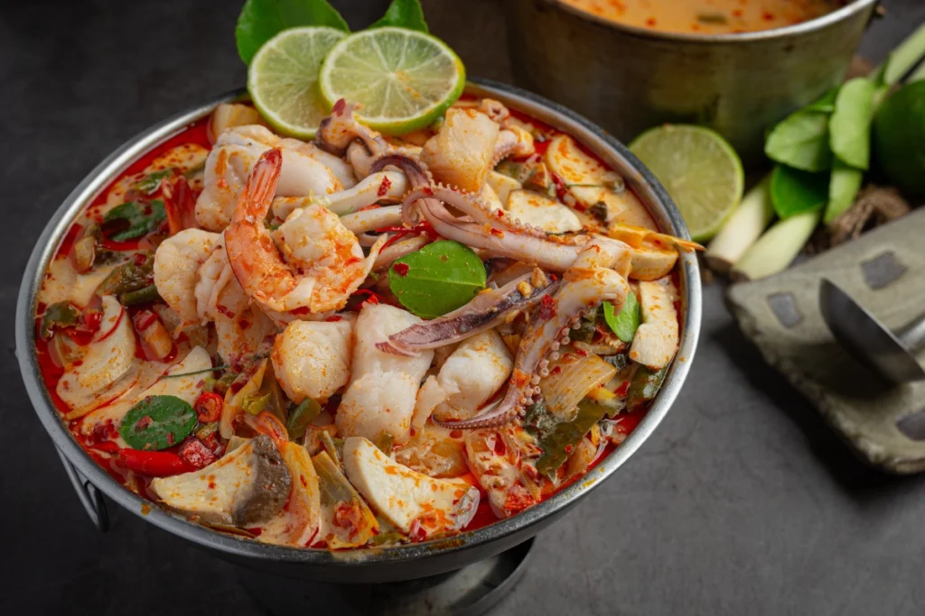 Assorted seafood boil with shrimp, crab, corn, and potatoes, served in a large pot, garnished with lemon slices and parsley, ready for a flavorful feast